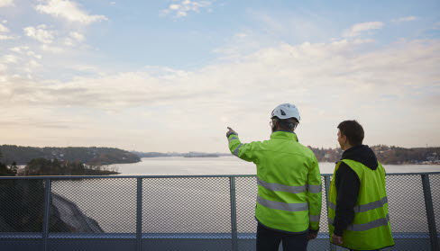 Two persons in high visibility cloything.