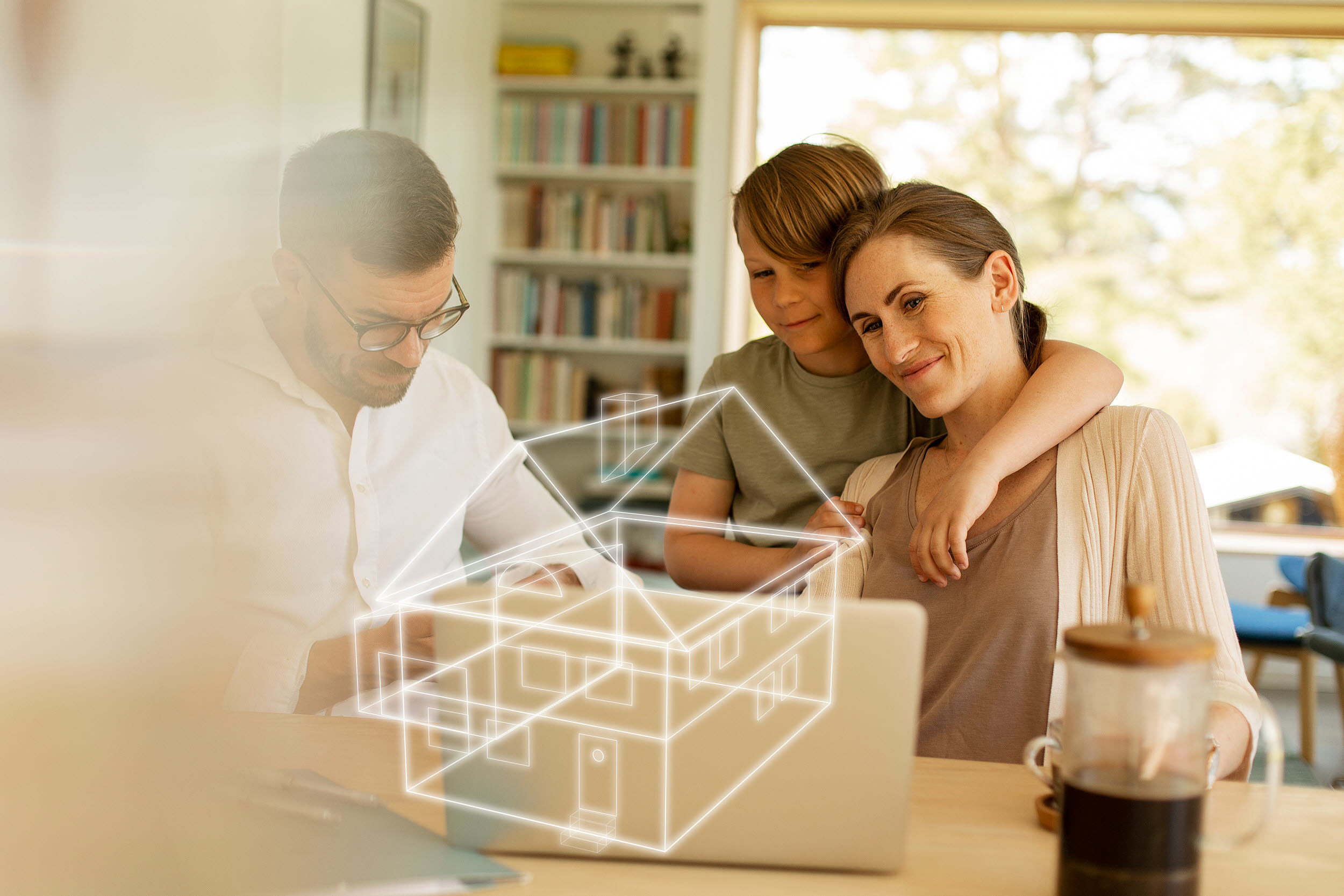 Familj tittar på en dator. En projeceras husritning i 3D syns också på bilden.