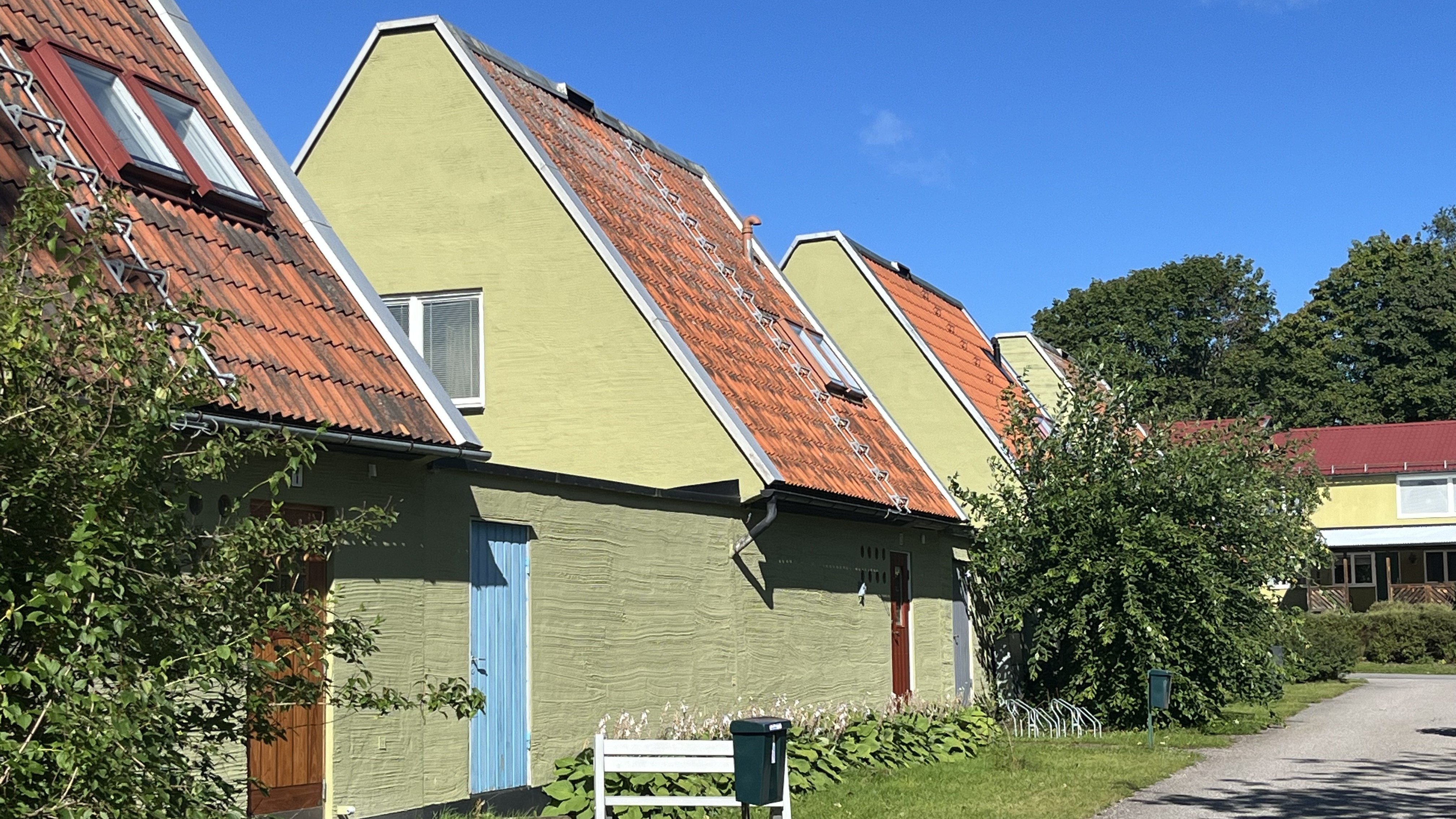 En rad gula hus med röda tegeltak