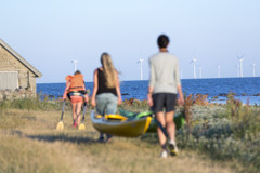 Familj går på land med båt på väg mot vattnet