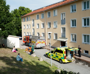 En brandbil och ambulans utanför ett hus. Foto: Franz Feldmanis