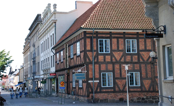 Foto på äldre korsvirkesbyggnad i stadsmiljö.